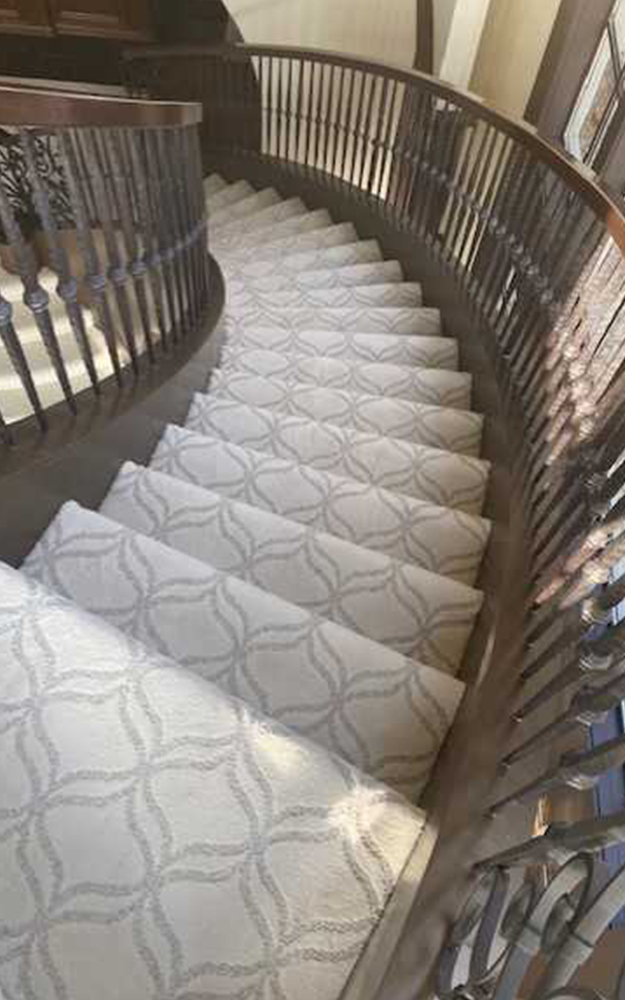 Spiral staircase installation detail featuring Shaw Appreciation Snowfall carpet